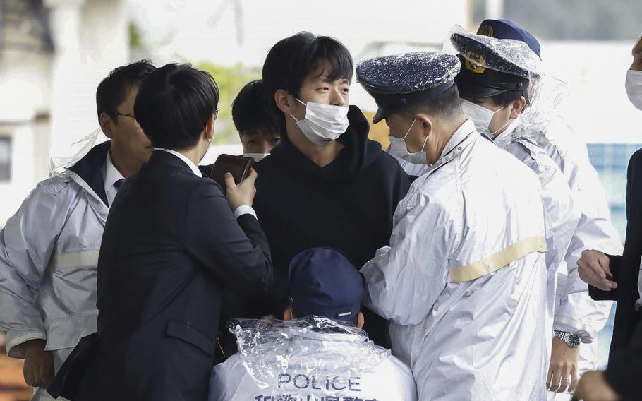 Ryuji Kimura, center, is caught by police.