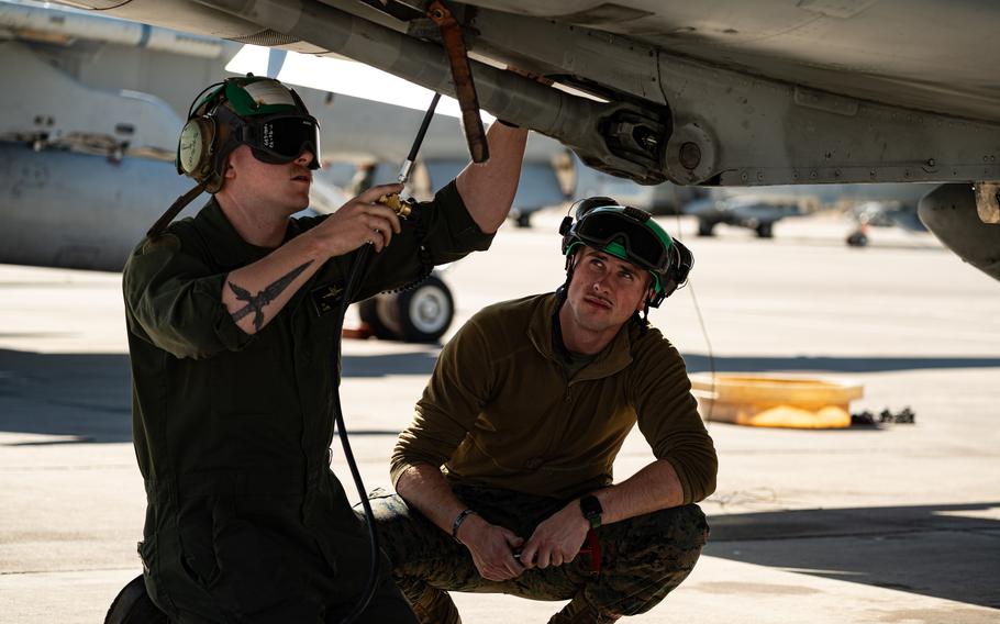 Airmen conduct maintenance on an aircraft