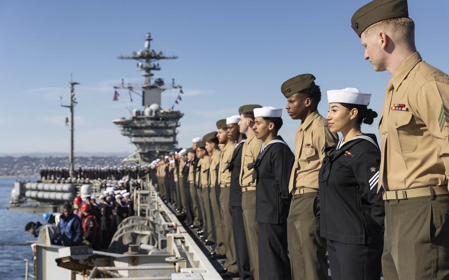 Sailors and Marines man the rails of the USS Abraham Lincoln