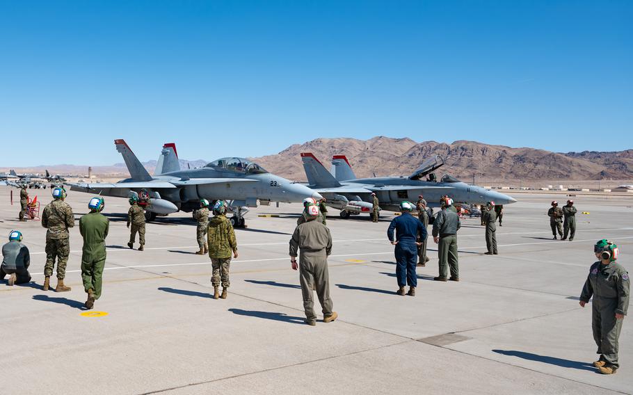 Airmen gather around two aircraft