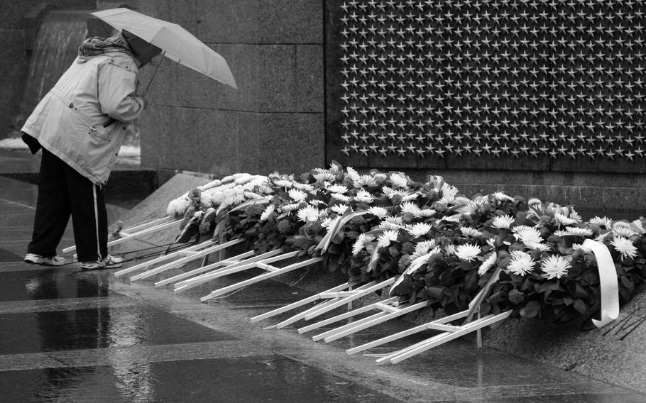  A visitor to the National World War II Memorial in Washington, D.C., looks at wreaths