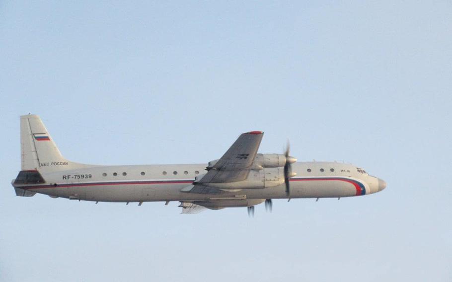 A Russian Ilyushin Il-18 plane is show mid air.