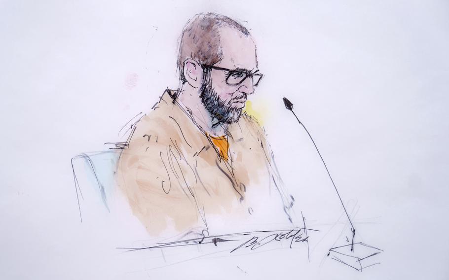 A courtroom sketch depicts a man wearing glasses and an orange prison jumpsuit sitting in front of a microphone.