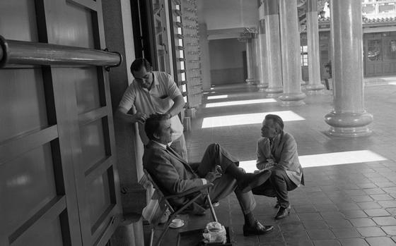 Taipei, Taiwan, Dec. 1, 1968: A hair and make-up artist touches up Gregory Peck as the actor talks to director J. Lee Thompson on the set of "The Chairman" at the Hsing Tien Kong Temple in Taipei. This is the fourth movie collaboration between the actor and director. Thompson directed Peck earlier in The Guns of Navarone (1961), Cape Fear (1962), and McKenna's Gold, which they filmed in 1967 but which will be released in 1969. 

META TAGS:Taiwan; entertainment; film industry; movie set; film location; celebrity