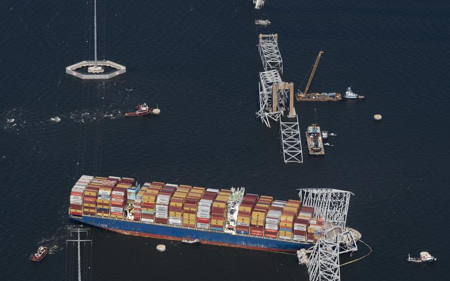 A container ship is caught in the wreckage of the collapsed bridge.