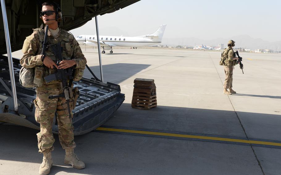 Then-Airman 1st Class Wilmer Puello-Mota, left, and Staff Sgt. Brandee Hahn, members of a 455th Expeditionary Security Forces Squadron flyaway security team, watch over a C130J-Super Hercules in 2015 at the former Hamid Karzai International Airport in Kabul, Afghanistan. Puello-Mota, who later served in the Massachusetts Air National Guard, is wanted in the United States on child pornography charges. He fled to Russia and is featured in a new Kremlin propaganda video talking about fighting for Russia in Ukraine.