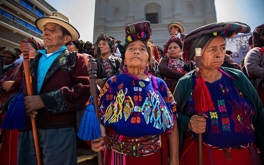 Indigenous Ixil people gather on the steps in front of the Catholic Church in Chajul, Guatemala, on May 10, 2023.