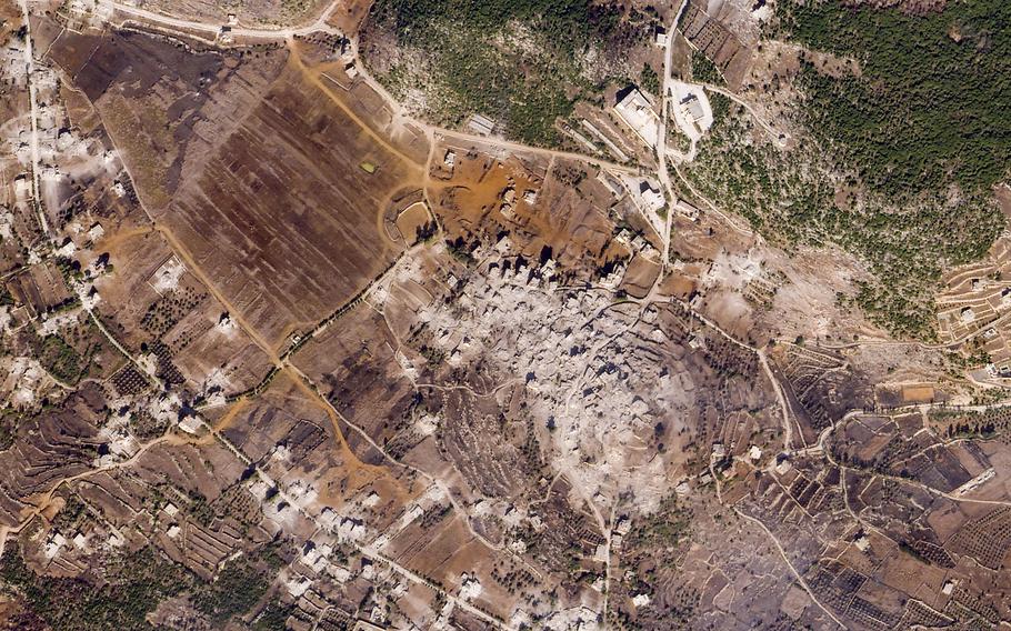 A satellite image of the Lebanese village of Ramyah, with a gray mass showing the rubble of destroyed buildings.