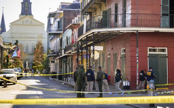 Agents in FBI jackets collect evidence on a city street in New Orleans.