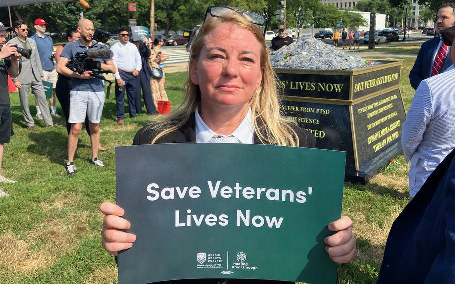Army veteran Lynn Krug holds a sign in support of veterans’ mental health care at a news conference in Washington on July 10, 2024.