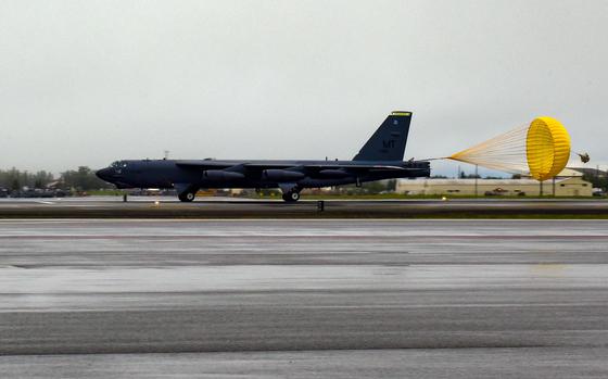 A drogue parachute helps a B-52H Stratofortress slow down upon landing ...