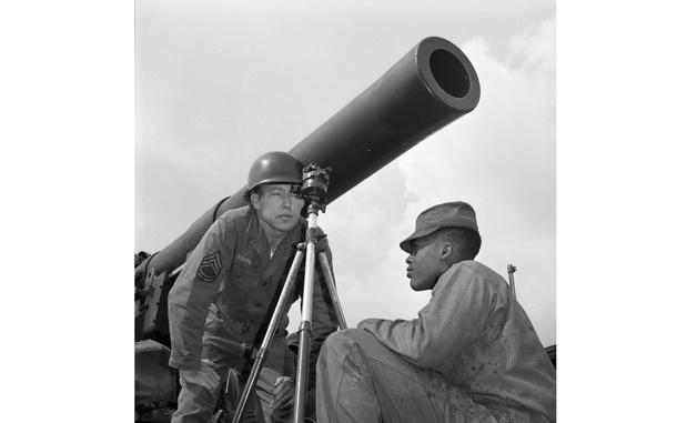 Sergeant First Class Freeman Tuberville, who serves with the 760th Field Artillery Battalion, B Battery, measures the firing range for the cannon behind him, assisted by an unknown Black soldier.

Looking for Stars and Stripes’ historic coverage? Subscribe to Stars and Stripes’ historic newspaper archive! We have digitized our 1948-1999 European and Pacific editions, as well as several of our WWII editions and made them available online through https://starsandstripes.newspaperarchive.com/

META TAGS: Army; Air Force; military family; way of life; military life; artillery; African-American; firing range; cannon