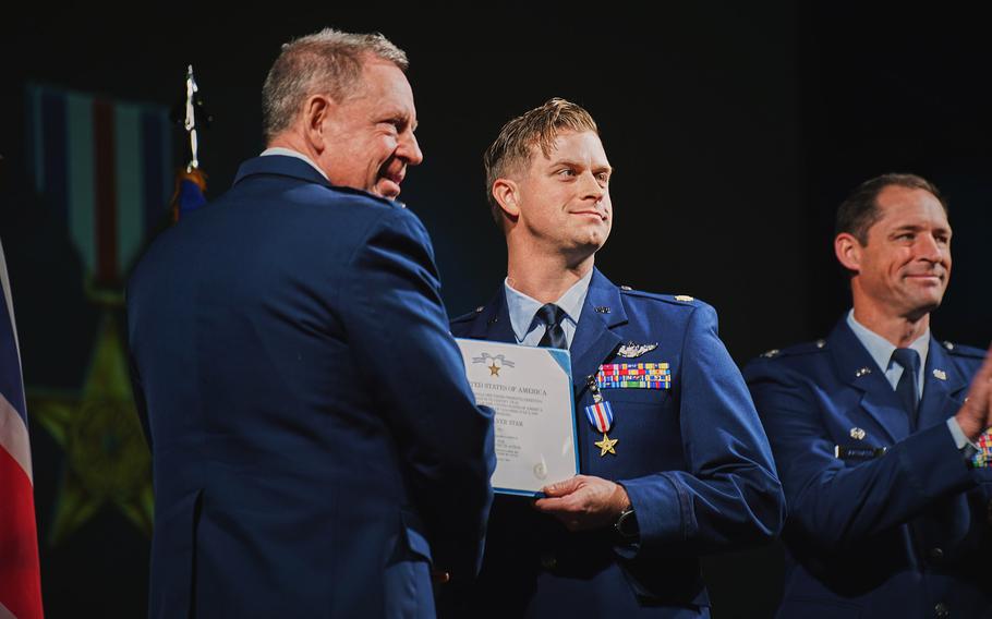 An airman receives an medal.