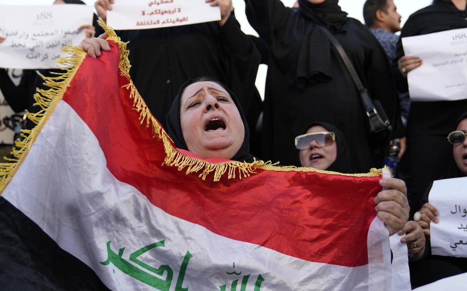 A woman waves a flag as part of a protest.