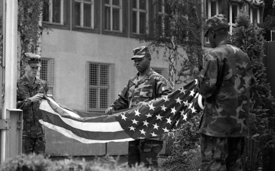 HED: Final Flag Lowering at Berlin Brigade Headquarters, 1994

Berlin, Germany, Sept. 7, 1994: Sgt. Brett Hickman (left), Sgt. David Rogers and Sgt. Alton Henderson from the Berlin Brigade perform the final retreat ceremony for the American flag at Clay Headquarters, marking the departure of U.S. troops from Berlin. 

Looking for Stars and Stripes’ historic coverage? Subscribe to Stars and Stripes’ historic newspaper archive! We have digitized our 1948-1999 European and Pacific editions, as well as several of our WWII editions and made them available online through https://starsandstripes.newspaperarchive.com/

META TAGS: Berlin Brigade; Army; West Germany; Europe; ceremony; flagpole; HQ; flag; African Americans; soldier; servicemember