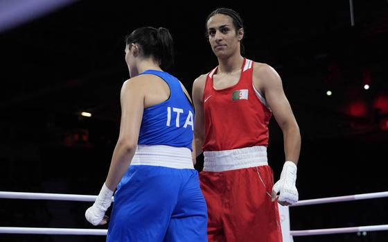 Algeria's Imane Khelif, right, walks beside Italy's Angela Carini after their women's 66kg preliminary boxing match at the 2024 Summer Olympics, Thursday, Aug. 1, 2024, in Paris, France. 