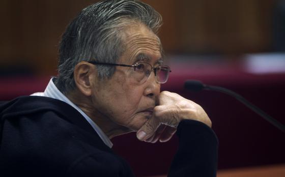 FILE - Peru's jailed, former President Alberto Fujimori, photographed through a glass window, attends his trial at a police base on the outskirts of Lima, Peru, June 28, 2016. His daughter Keiko Fujimori announced in a post on X that he died of cancer on Wednesday, September 11, 2024. (AP Photo/Martin Mejia, File)