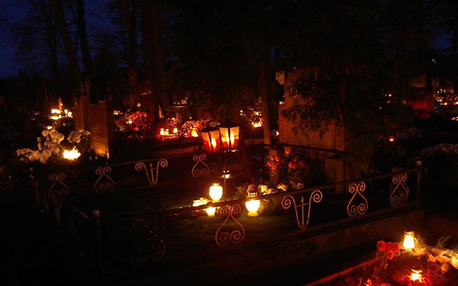 Candles burn in a cemetery in honor of All Saints’ Day.