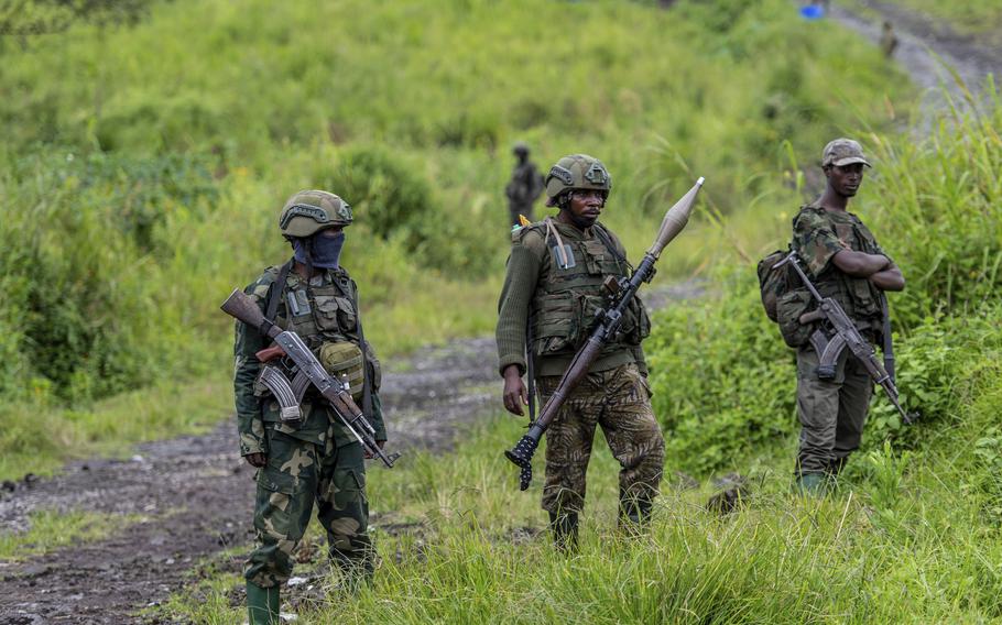 M23 rebels stand with their weapons in Kibumba, in the eastern of Democratic Republic of Congo.