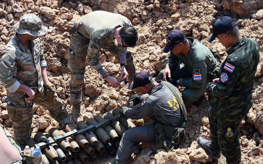 Explosive ordinance specialists with the U.S. and Thai armies lay C4.