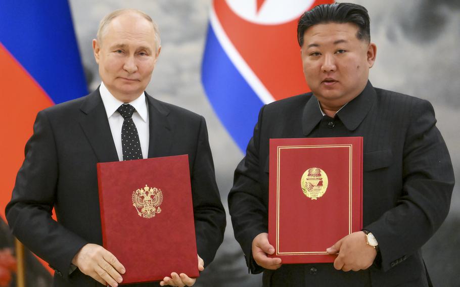 Russian President Vladimir Putin, left, and North Korea’s leader Kim Jong Un pose for a photo during a signing ceremony of the new partnership in Pyongyang, North Korea, on June 19, 2024.