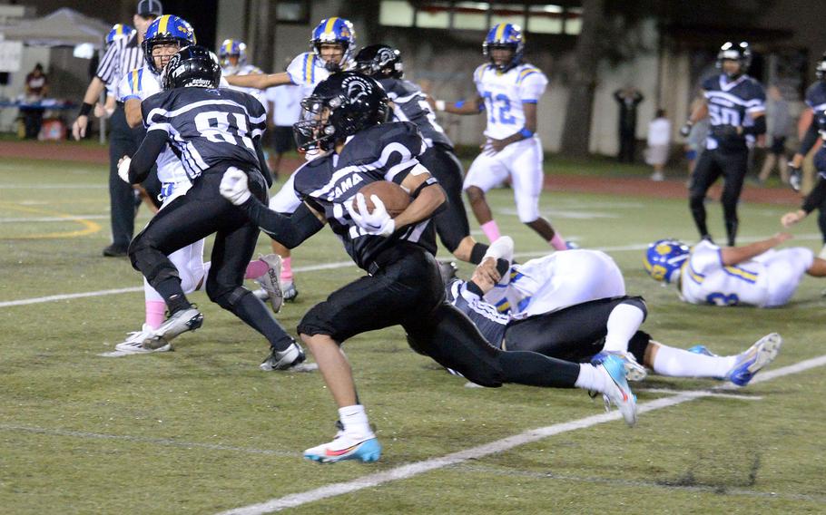 Zama's Hiroki Davis skirts left end en route to a 31-yard touchdown run.