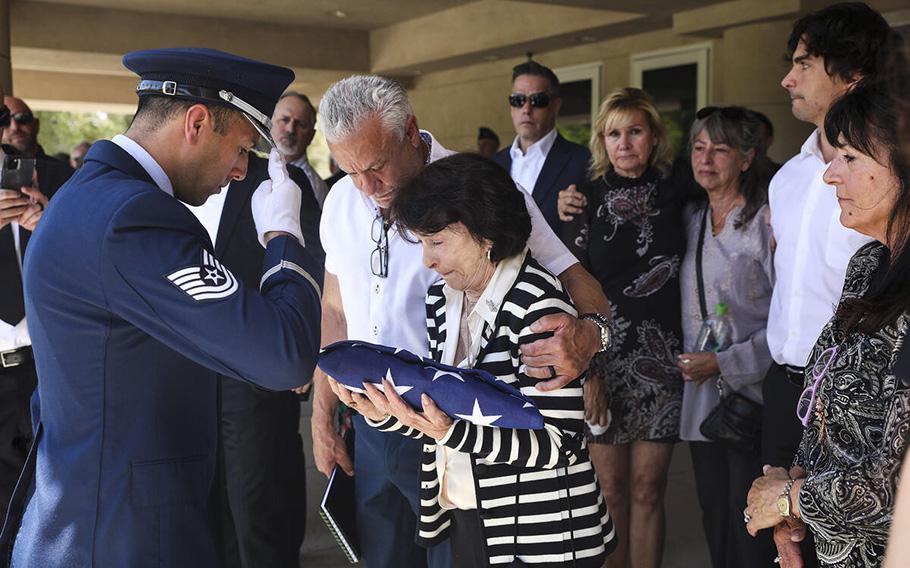 An Air Force member presents a flag to the late Air Force Col. James Abraham’s wife, Jo Abraham, at his funeral at the Southern Nevada Veterans Memorial Cemetery in Boulder City, Nevada, on Monday, May 15, 2023. 