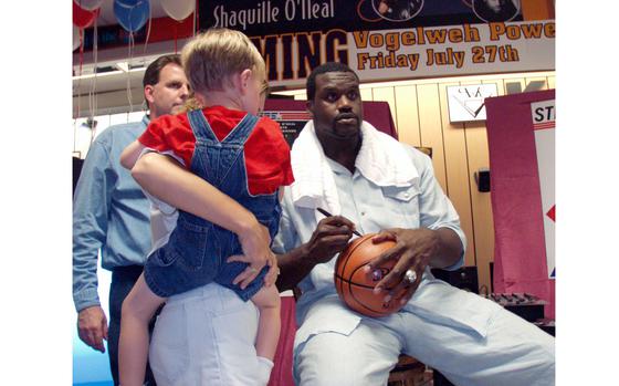 HED: Famous Fulda High Alum, 2001

Vogelweh, Germany, July 27, 2001: Shaquille O'Neal, who played basketball at Fulda High School as a sophomore, signs a basketball for a young fan at the Vogelweh Powerzone. O'Neal visited Ramstein Air Base, Landstuhl Regional Medical Center and Vogelweh on a tour promoting his new CD titled "Shaquille O'Neal Presents His Superfriends." There were more than 400 fans at the store to get autographs.

META TAGS: Basketball; military child; military brat; Fulda High School; military family