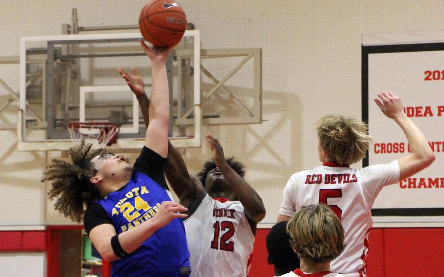 Brailyn Ivey and Nicholas Whyte jump for the ball.