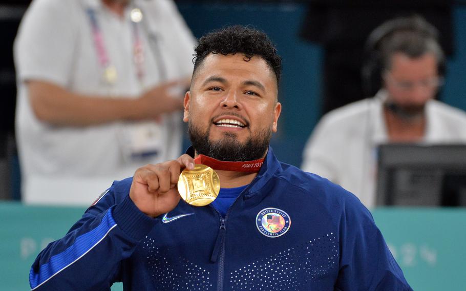 Jorge Salazar, a Marine Corps veteran, shows off his gold medal after the U.S. wheelchair basketball team defeated Great Britain 73-69 at the 2024 Paris Paralympics, Sept. 7, 2024.