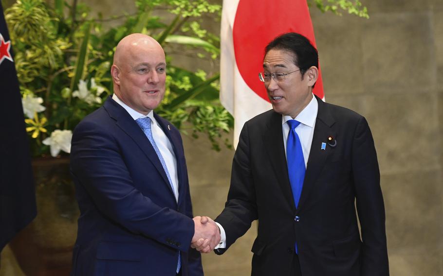 New Zealand Prime Minister Christopher Luxon, left, and Japan Prime Minister Fumio Kishida shake hands prior to their bilateral meeting at Kishida’s office in Tokyo Wednesday, June 19, 2024.