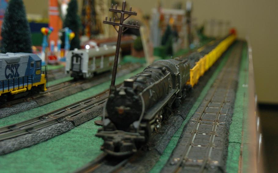 A model train races along a track.