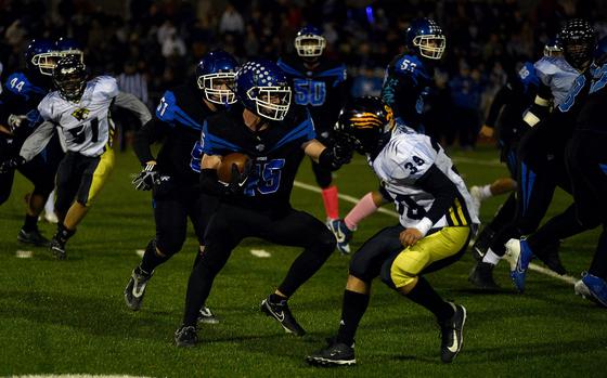 Ramstein running back Kydan Echard stiff-arms Stuttgart senior Zach Poe during the Division I DODEA European championship game on Nov. 1, 2024, at Ramstein High School on Ramstein Air Base, Germany.