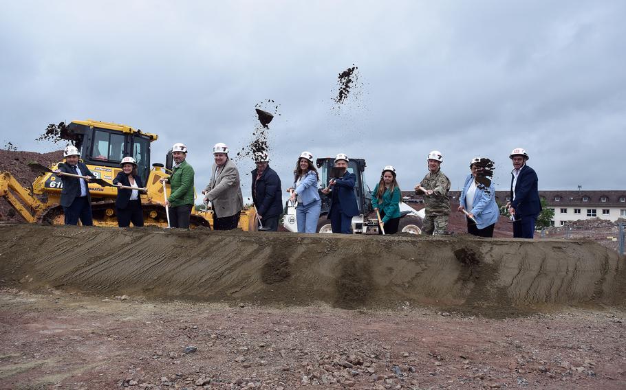 Assorted officials have fun tossing dirt up into the air at the groundbreaking ceremony Wednesday, May 29, 2024, for a new elementary school at Baumholder, a U.S. Army post in southwestern Germany.