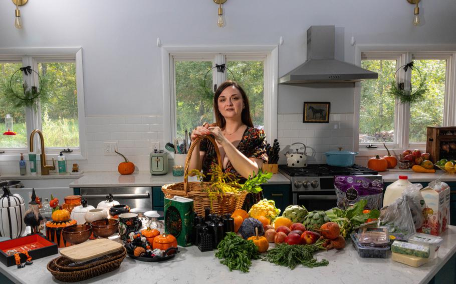 Lynzi Judish prepares produce and seasonal decor that she will put into her refrigerator. Her fridge will be Halloween-themed. 