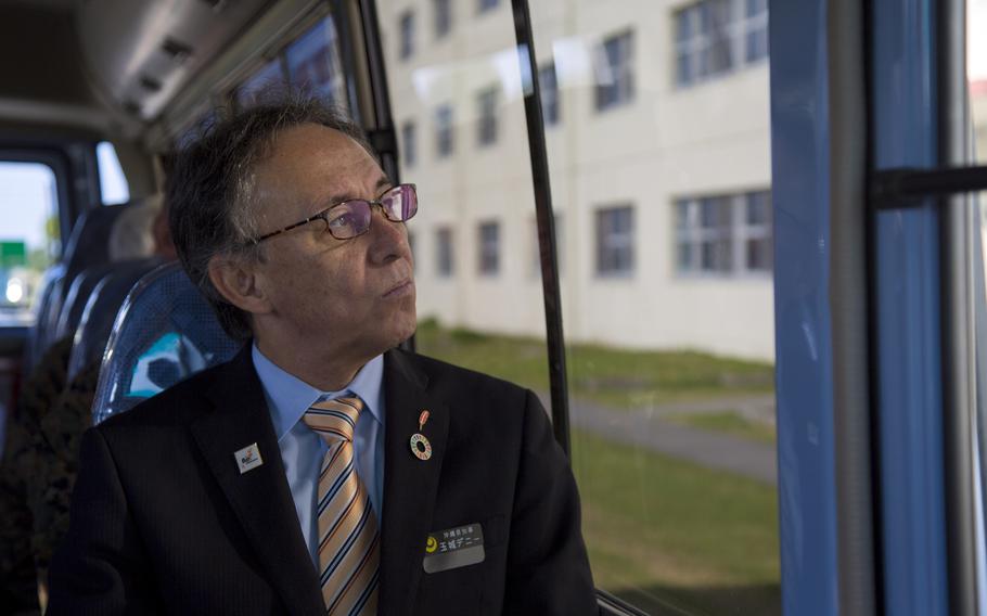 Okinawa Gov. Denny Tamaki tours Camp Kinser, a Marine Corps base on the island, in January 2019. 