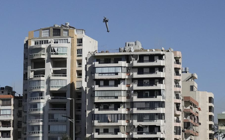 An airborne Israeli missile closes in on a building in Beirut.