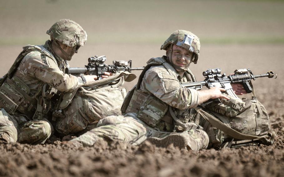 Two soldiers with the 173rd Airborne Brigade provide security after parachuting into a field outside of the Joint Multinational Readiness Center Hohenfels Training Area, Germany, for Exercise Saber Junction on Sept. 4, 2024. The multinational land warfare exercise incorporated battlefield lessons from the Ukraine war.