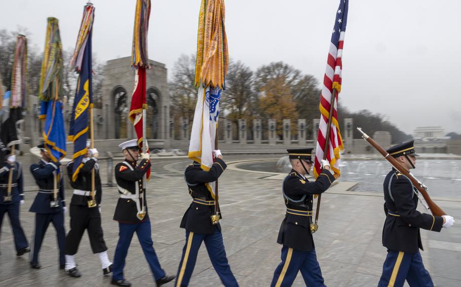 Troops carrying flags at the ceremony.