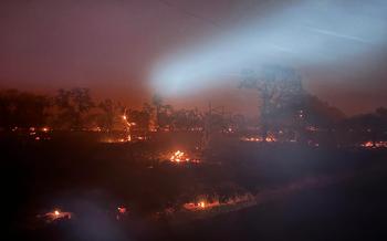 The fire moves quickly through the dry brush north of Mike Waltz’s property just east of Chico, California.