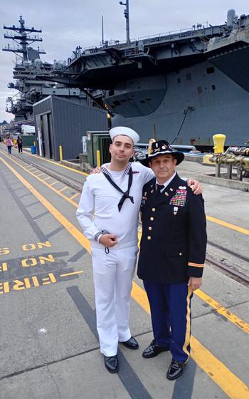 Navy Airman Lafayette Eugene Gardner, left, is greeting by his father, former Army Chief Warrant Officer Eugene Gardner, on the pier next to the USS Ronald Reagan at Naval Base Kitsap, Wash.