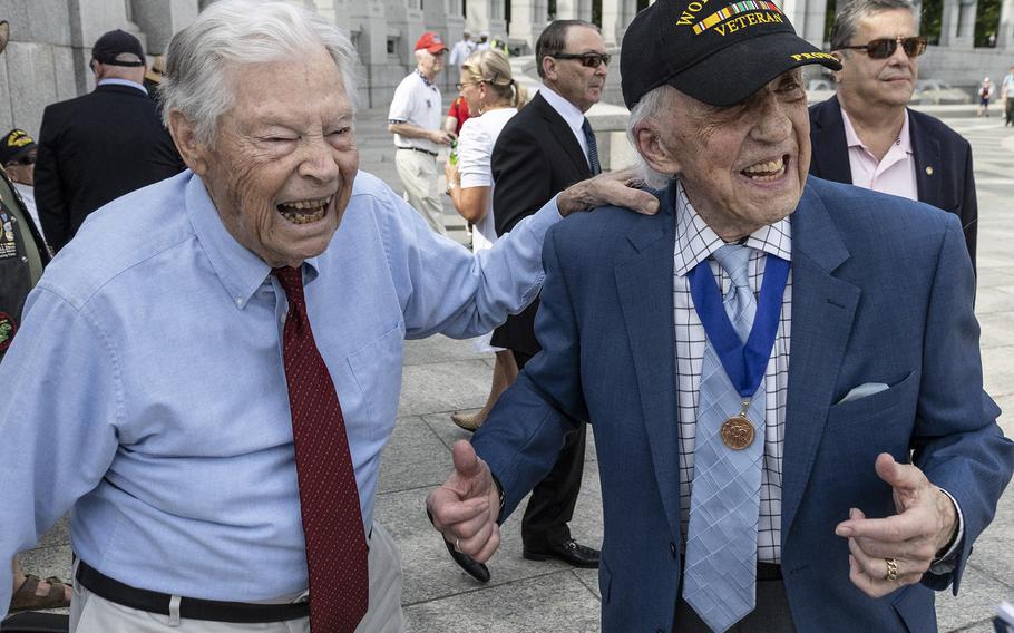 World War II veterans Les Jones, left, and Dave Yoho share a laugh before the 20th anniversary celebration of the National World War II Memorial in Washington, May 25, 2024.