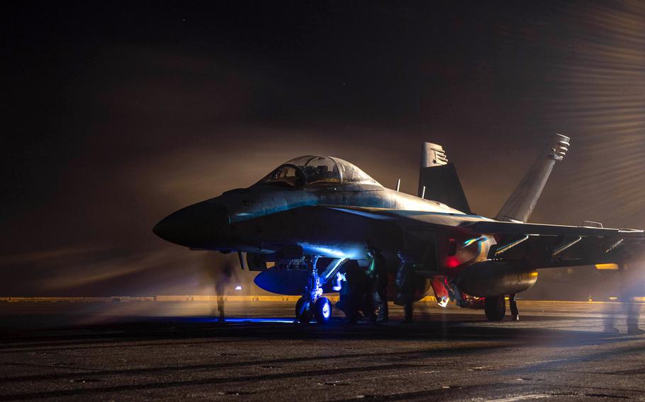 Sailors prepare an E/A-18G Growler for launch aboard the aircraft carrier USS Dwight D. Eisenhower in the Red Sea on April 16, 2024.