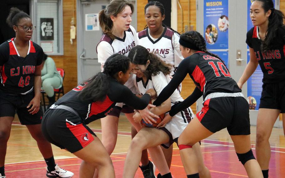 Players from Zama and E.J. King fight for the basketball.