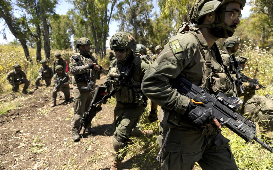 Israeli reserve combat soldiers of the 134th battalion take part at a training drill on May 8, 2024 in Golan Heights. The training exercise simulating operational scenarios on the Lebanese front and include live fire of tanks and infantry troops, amid the conflict simmering along Israel’s northern border with Lebanon, where there has been regular cross-border fire between Israel and Hezbollah, the Lebanese militant political group allied with Hamas. 