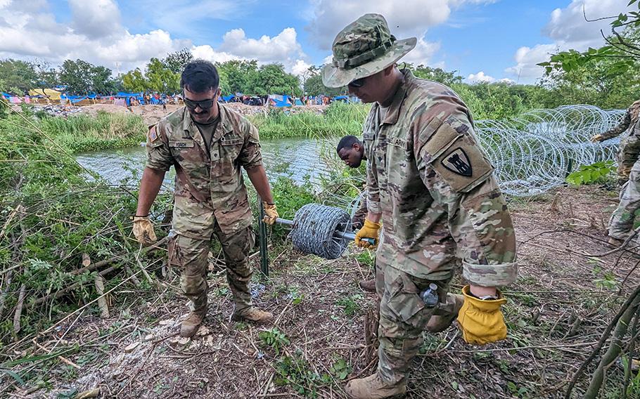 Servicemembers assisting on Operation Lone Star construct a concertina wire barrier on the banks of the Rio Grande River in Brownsville Texas, on May 19, 2023. The servicemembers’ presence on the border is meant to deter illegal immigration crossing the river into Texas.