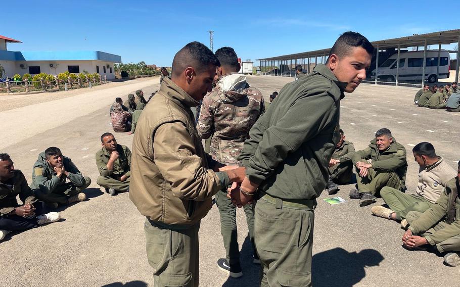 Syrian Democratic Forces trainees practice prisoner restraint techniques in Syria.