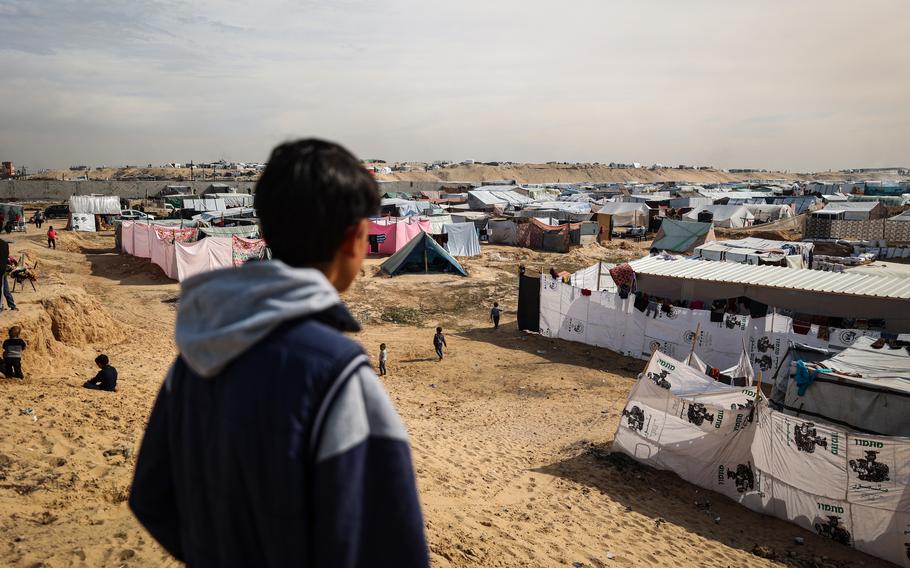 A man looks over a camp that houses thousands of displaced people south of Rafah on Jan. 21, 2024.