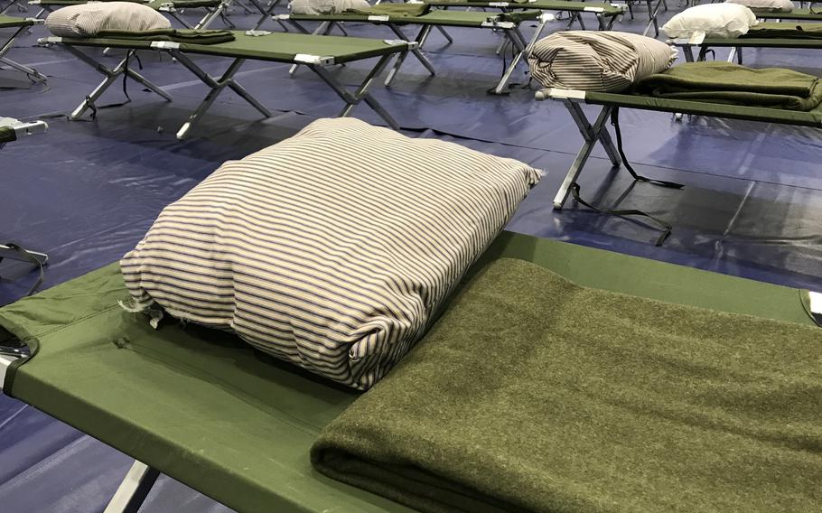 Rows of empty cots stand ready at an evacutaion center in the Northside Iron Works Gym at Marine Corps Air Station Iwakuni, Japan, Friday, Aug. 30, 2023. 