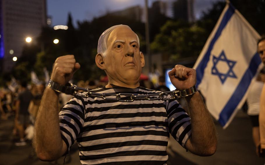 An Israeli activist wears a mask depicting Israeli Prime Minister Benjamin Netanyahu as thousands demonstrate against the government in Tel Aviv on July 6, 2024.